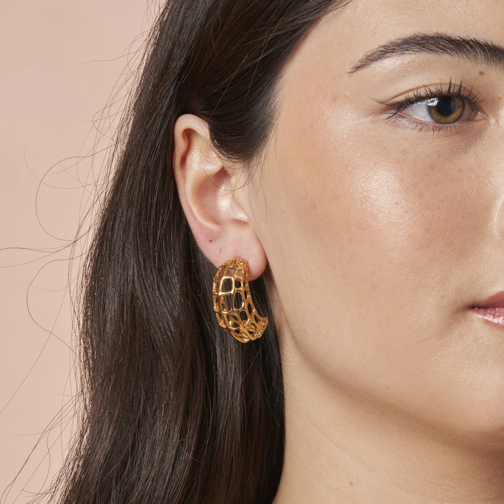 woman wearing Amalie Gold Earrings Large by Ixora Jewelers