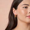 woman wearing Amalie Gold Earrings by Ixora Jewelers