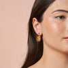 woman wearing Coral Burst Earrings by Ixora Jewelers