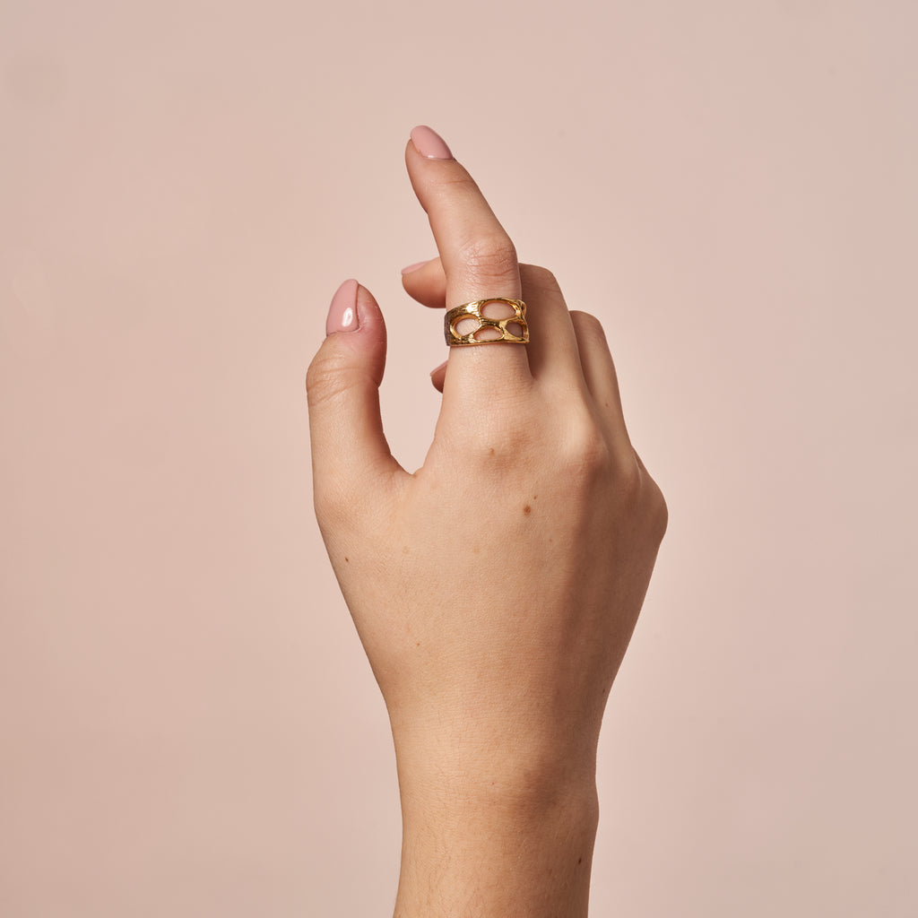 woman wearing Coki Gold Ring by Ixora Jewelers